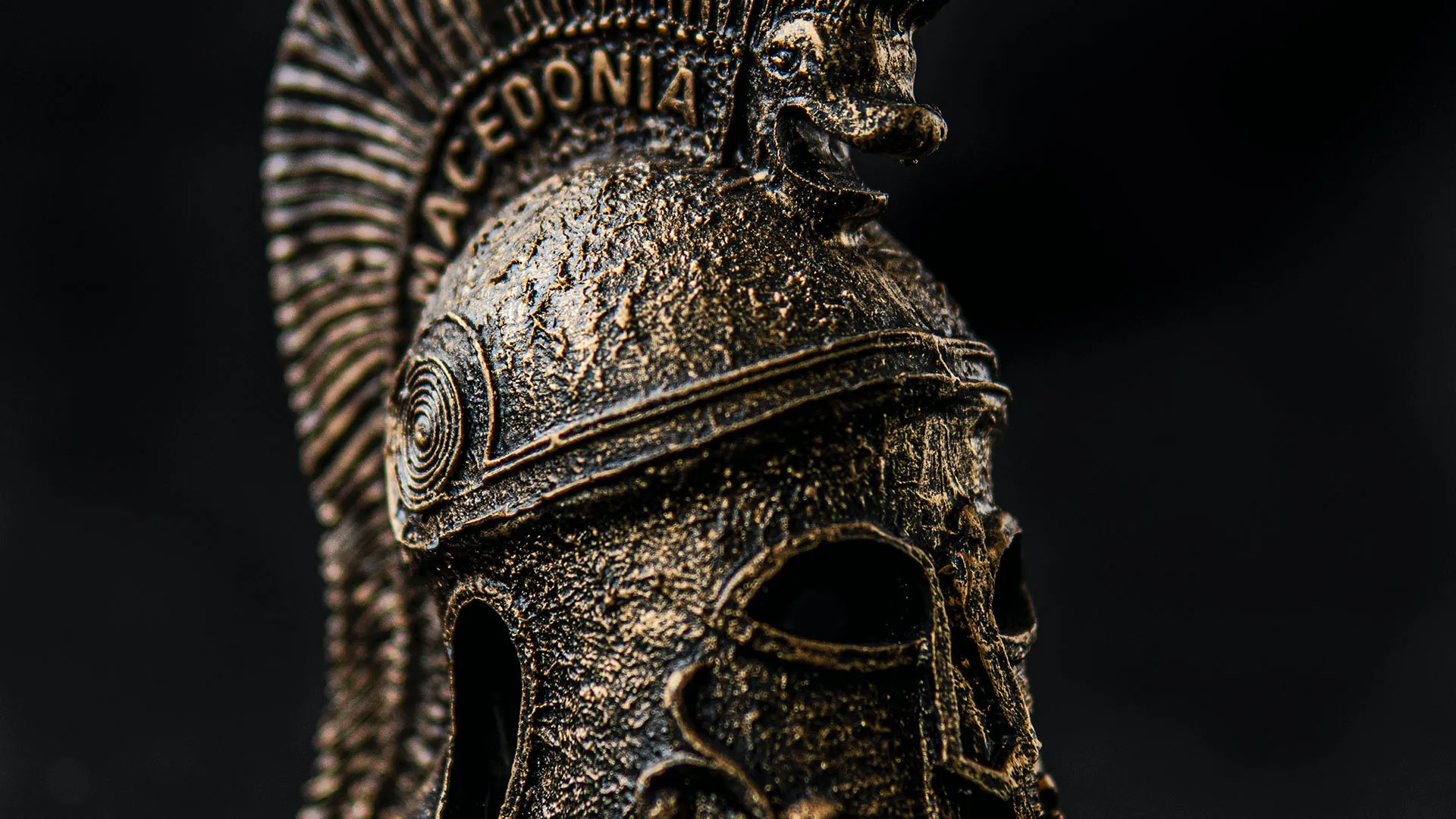 Old Spartan helmet with ornament on black background