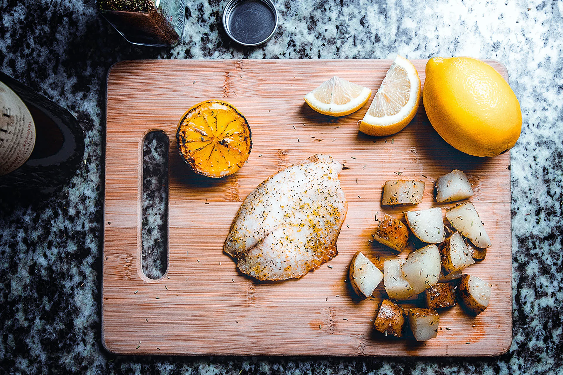 Lemon slices with fish on wooden board